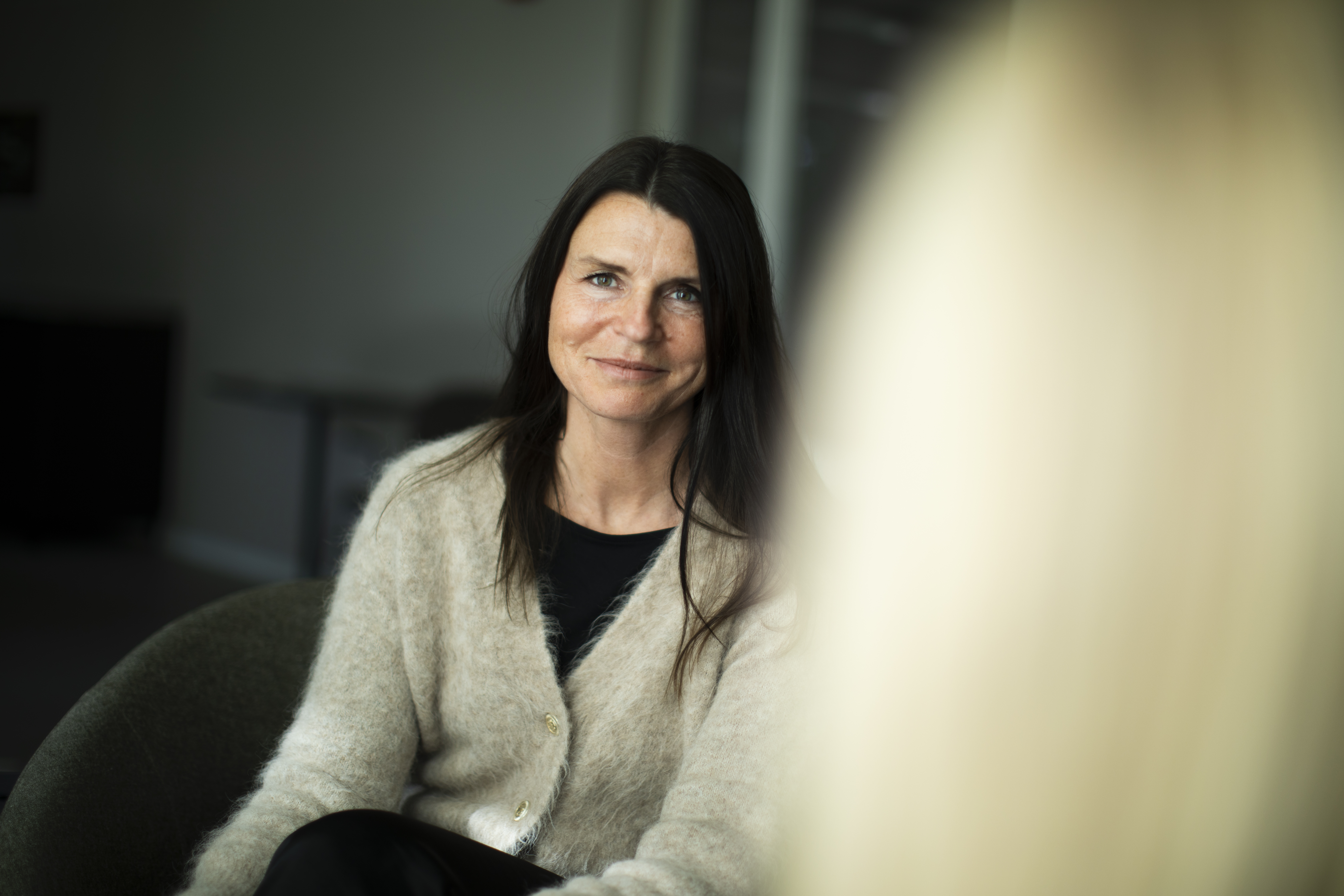 Bodil sitter ner och ler in i kameran